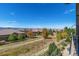 Backyard view of neighborhood featuring trees, grass and mountain views at 10731 Featherwalk Ln, Highlands Ranch, CO 80126