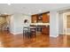 Stylish bar area with wood cabinets, a sink, a beverage cooler, and hardwood floors at 10731 Featherwalk Ln, Highlands Ranch, CO 80126