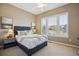 Inviting bedroom with large windows, comfortable bed, and soothing decor at 10731 Featherwalk Ln, Highlands Ranch, CO 80126