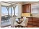 Dining area with glass table and chairs leading to covered patio with great views at 10731 Featherwalk Ln, Highlands Ranch, CO 80126