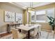 Elegant dining room featuring a modern light fixture, neutral decor, and a large window at 10731 Featherwalk Ln, Highlands Ranch, CO 80126