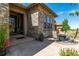 Home exterior detail showing a stone facade, front porch, and an outdoor seating area at 10731 Featherwalk Ln, Highlands Ranch, CO 80126