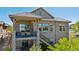 Exterior view of a home with a stone facade, upper-level balcony, and well-maintained landscaping at 10731 Featherwalk Ln, Highlands Ranch, CO 80126
