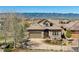 Beautifully landscaped home featuring a stone and tile exterior and an attached two car garage at 10731 Featherwalk Ln, Highlands Ranch, CO 80126