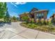 This home features a stone and tile exterior, two car garage, and beautiful garden landscaping at 10731 Featherwalk Ln, Highlands Ranch, CO 80126
