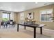 Spacious game room featuring a ping pong table and access to an outdoor patio at 10731 Featherwalk Ln, Highlands Ranch, CO 80126