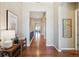 Long hallway with wood flooring and neutral walls leading to other rooms in the house at 10731 Featherwalk Ln, Highlands Ranch, CO 80126