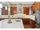 Bright kitchen featuring stainless steel appliances, a large island, white countertops and hardwood floors at 10731 Featherwalk Ln, Highlands Ranch, CO 80126