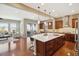 Spacious kitchen with an island, hardwood floors, stainless steel appliances, and views of the living room at 10731 Featherwalk Ln, Highlands Ranch, CO 80126