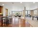 Open-concept living area with hardwood floors, multiple seating areas, and abundant natural light at 10731 Featherwalk Ln, Highlands Ranch, CO 80126