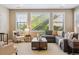 Cozy living room with a sectional sofa, accent chairs, and large windows with blinds at 10731 Featherwalk Ln, Highlands Ranch, CO 80126