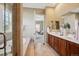 Bright bathroom features a double sink vanity, soaking tub and entry to the main bedroom at 10731 Featherwalk Ln, Highlands Ranch, CO 80126