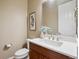 Powder room with modern sink, wood cabinet, and framed art at 10731 Featherwalk Ln, Highlands Ranch, CO 80126