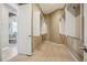 Spacious walk-in closet with custom shelving, adjacent to a luxurious bathroom at 10731 Featherwalk Ln, Highlands Ranch, CO 80126