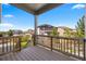 A well-kept back porch with wood railing and nice view of the green lawns and neighborhood at 12210 Pine Post Dr, Parker, CO 80138