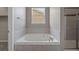 Bathroom features a tiled tub and shower, offering a relaxing and functional space at 12210 Pine Post Dr, Parker, CO 80138