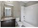 Bathroom features a shower-tub combo, modern fixtures, and a vanity sink with storage at 12210 Pine Post Dr, Parker, CO 80138