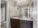 Bathroom featuring double vanity, modern fixtures, and a mirror reflecting the natural light from the hall at 12210 Pine Post Dr, Parker, CO 80138