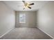 Bedroom featuring neutral carpet, light gray walls, natural light from a window, and overhead ceiling fan at 12210 Pine Post Dr, Parker, CO 80138