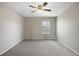 Bedroom featuring neutral carpet, light gray walls, natural light from a window, and overhead ceiling fan at 12210 Pine Post Dr, Parker, CO 80138