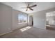 Bedroom with neutral carpet, natural light, light gray walls, and an ensuite bathroom at 12210 Pine Post Dr, Parker, CO 80138