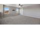 Bonus room offering versatile space with neutral carpet, ceiling fan, and ample natural light at 12210 Pine Post Dr, Parker, CO 80138