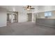 Large bonus room featuring neutral carpet, light gray walls, and natural light from multiple windows at 12210 Pine Post Dr, Parker, CO 80138