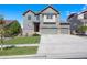 Charming two-story home with a well-maintained lawn and a three-car garage at 12210 Pine Post Dr, Parker, CO 80138