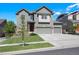 Charming two-story home with a well-maintained lawn and a three-car garage at 12210 Pine Post Dr, Parker, CO 80138
