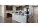 Modern kitchen with dark cabinets, stainless steel appliances, and granite countertops at 12210 Pine Post Dr, Parker, CO 80138
