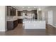 Modern kitchen with dark cabinets, stainless steel appliances, and granite countertops at 12210 Pine Post Dr, Parker, CO 80138