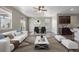 Open-concept living room with a ceiling fan, fireplace, and access to a deck at 12210 Pine Post Dr, Parker, CO 80138