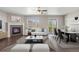Living room featuring a fireplace, access to the patio, and modern furnishings at 12210 Pine Post Dr, Parker, CO 80138