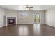 Living room featuring a fireplace, access to the patio, and plenty of natural light at 12210 Pine Post Dr, Parker, CO 80138