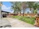 A spacious backyard with a patio, an outdoor lounge area, and mature trees at 309 Lincoln Ave, Platteville, CO 80651