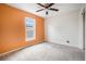 A cozy bedroom with a ceiling fan, a bright window, and a single painted accent wall at 309 Lincoln Ave, Platteville, CO 80651