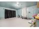 Large garage with blue walls and painted white flooring, ideal for storage or projects at 309 Lincoln Ave, Platteville, CO 80651