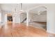 Open-concept living room with a fireplace, hardwood flooring, and a staircase at 309 Lincoln Ave, Platteville, CO 80651