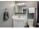 Compact bathroom featuring vanity, white sink, stylish faucet, and tiled backsplash at 1204 S Uvalda St, Aurora, CO 80012