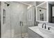 Modern bathroom featuring marble-tiled shower with glass door, vanity with sink, and an illuminated mirror at 1204 S Uvalda St, Aurora, CO 80012