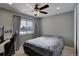 This bedroom offers a ceiling fan, natural light, and comfortable space for rest and relaxation at 1204 S Uvalda St, Aurora, CO 80012