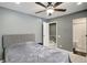 Bright bedroom offers a ceiling fan and a view to the updated en suite bathroom with shower at 1204 S Uvalda St, Aurora, CO 80012