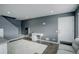 Comfortable living room with gray walls, white accents, and wood-look floors at 1204 S Uvalda St, Aurora, CO 80012