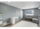Cozy living room with plush rug, gray sofa, and lots of natural light at 1204 S Uvalda St, Aurora, CO 80012