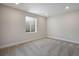 Basement bedroom with a large window and neutral carpeting at 1580 E 3Rd Ave, Longmont, CO 80501