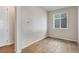 Cozy bedroom offers natural light from the window, neutral paint, and hardwood floors throughout the space at 1580 E 3Rd Ave, Longmont, CO 80501