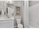 Bright bathroom featuring a white vanity, framed art, toilet, and a shower with white tile surround at 4338 Cattle Cross Trl, Castle Rock, CO 80104