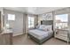 Comfortable bedroom with a plush bed, mirrored nightstands, and lots of natural light at 4338 Cattle Cross Trl, Castle Rock, CO 80104
