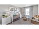 A cozy Bedroom with a white crib, modern gray walls, and neutral tones at 4338 Cattle Cross Trl, Castle Rock, CO 80104