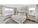 Bright bedroom featuring a bed with a white pattern, a dresser, art, and large windows at 4338 Cattle Cross Trl, Castle Rock, CO 80104